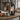 Rustic electric lantern lamp glowing on a farmhouse kitchen counter beside pastries and a mug