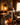 Rustic electric lantern lamp on a stone fireplace mantel in a cozy cabin